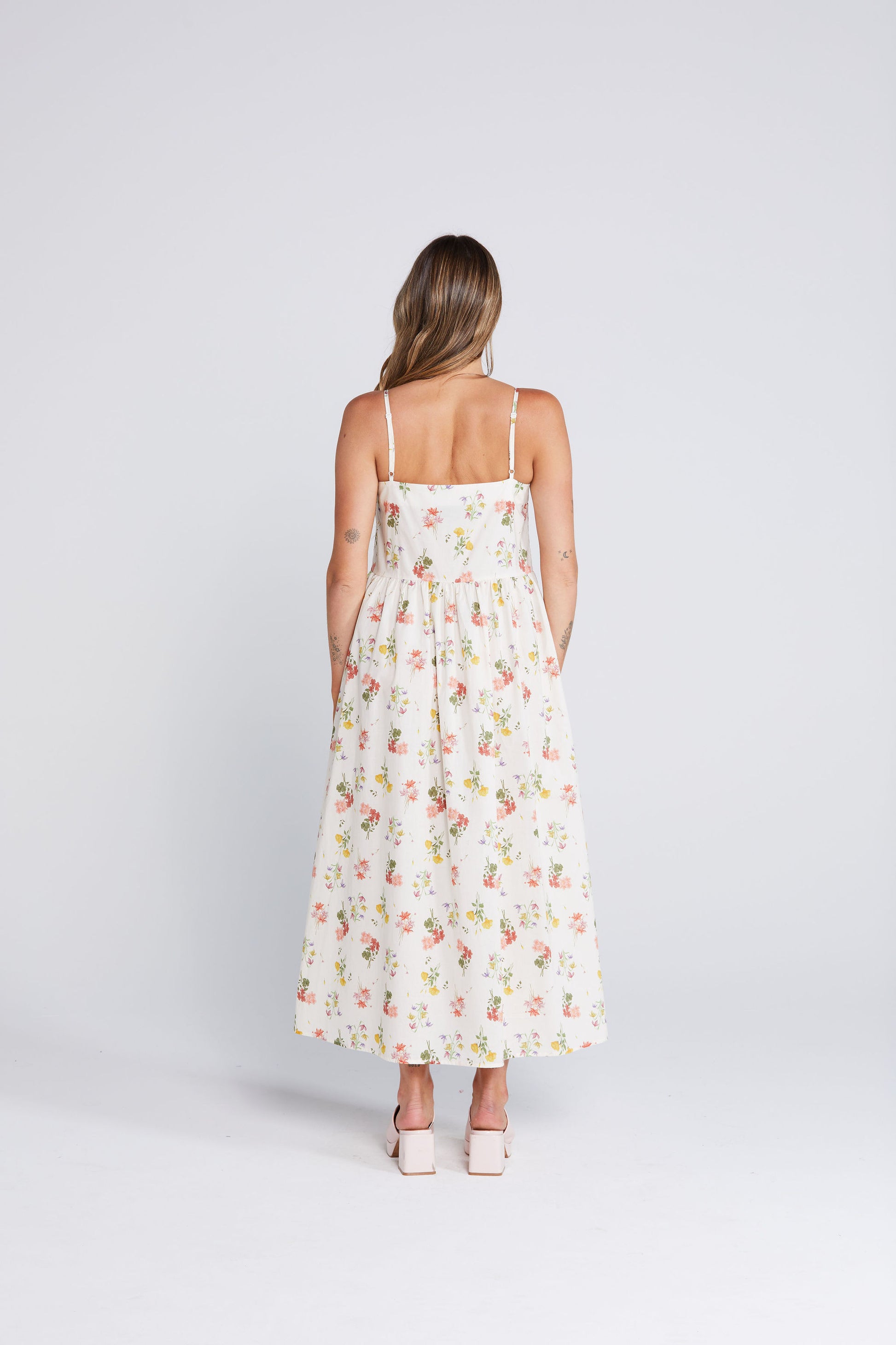 Woman wearing a floral dress on a white background