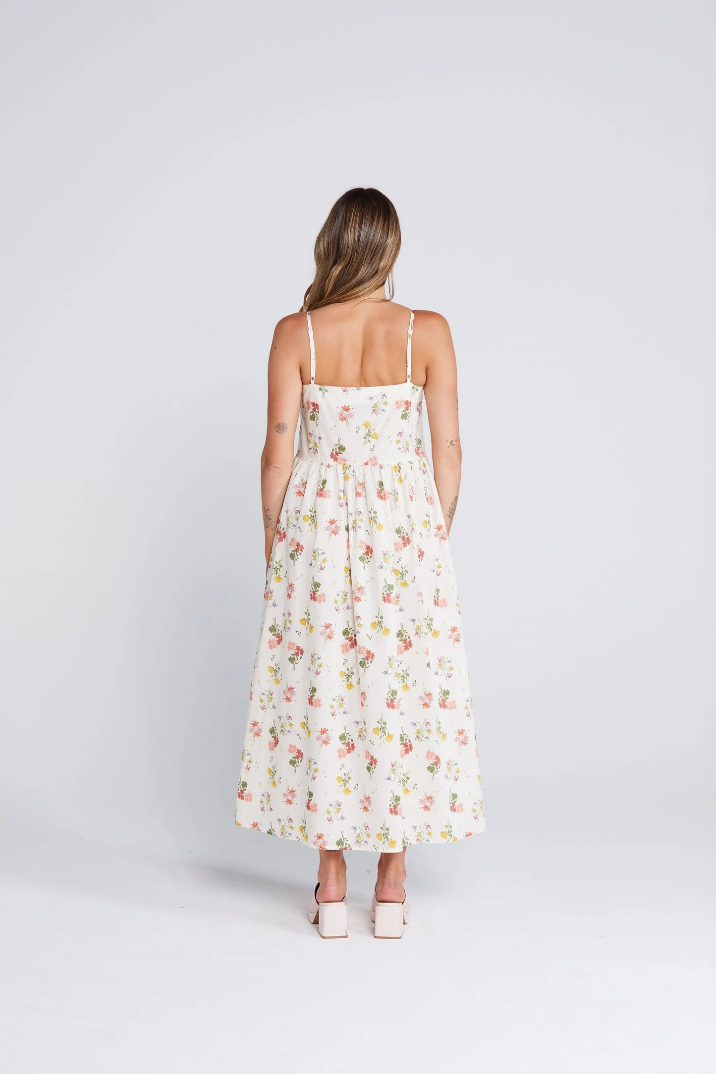 Woman wearing a floral dress on a white background