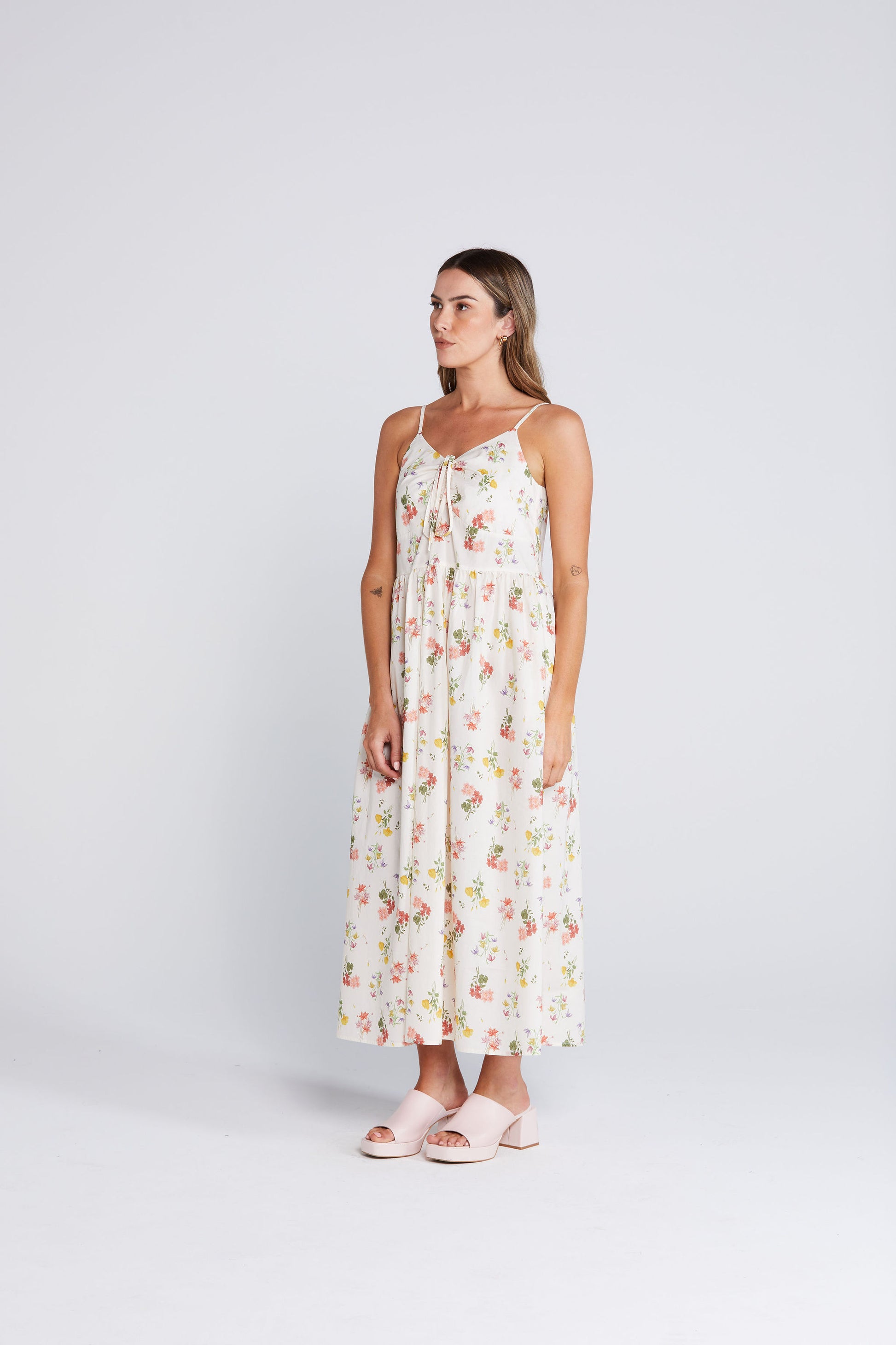 Woman wearing a floral dress on a white background