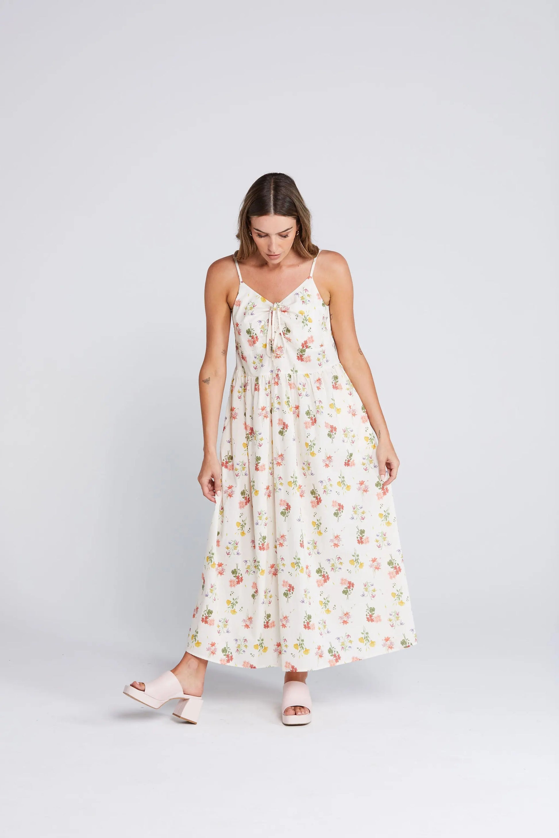 Woman wearing a floral dress on a white background