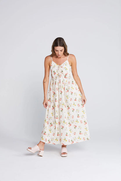 Woman wearing a floral dress on a white background. Zinnia Dress Summer Haven Front View - The Rose Edit