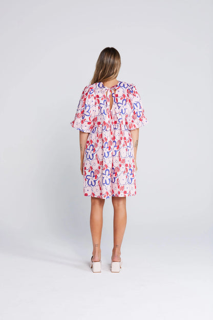 Woman wearing a colorful dress with a white background