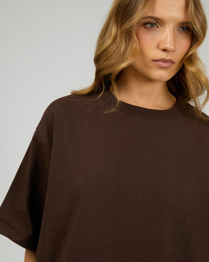 Woman wearing a brown oversized t-shirt against a plain background. Core Oversized Tee Chocolate - The Rose Edit