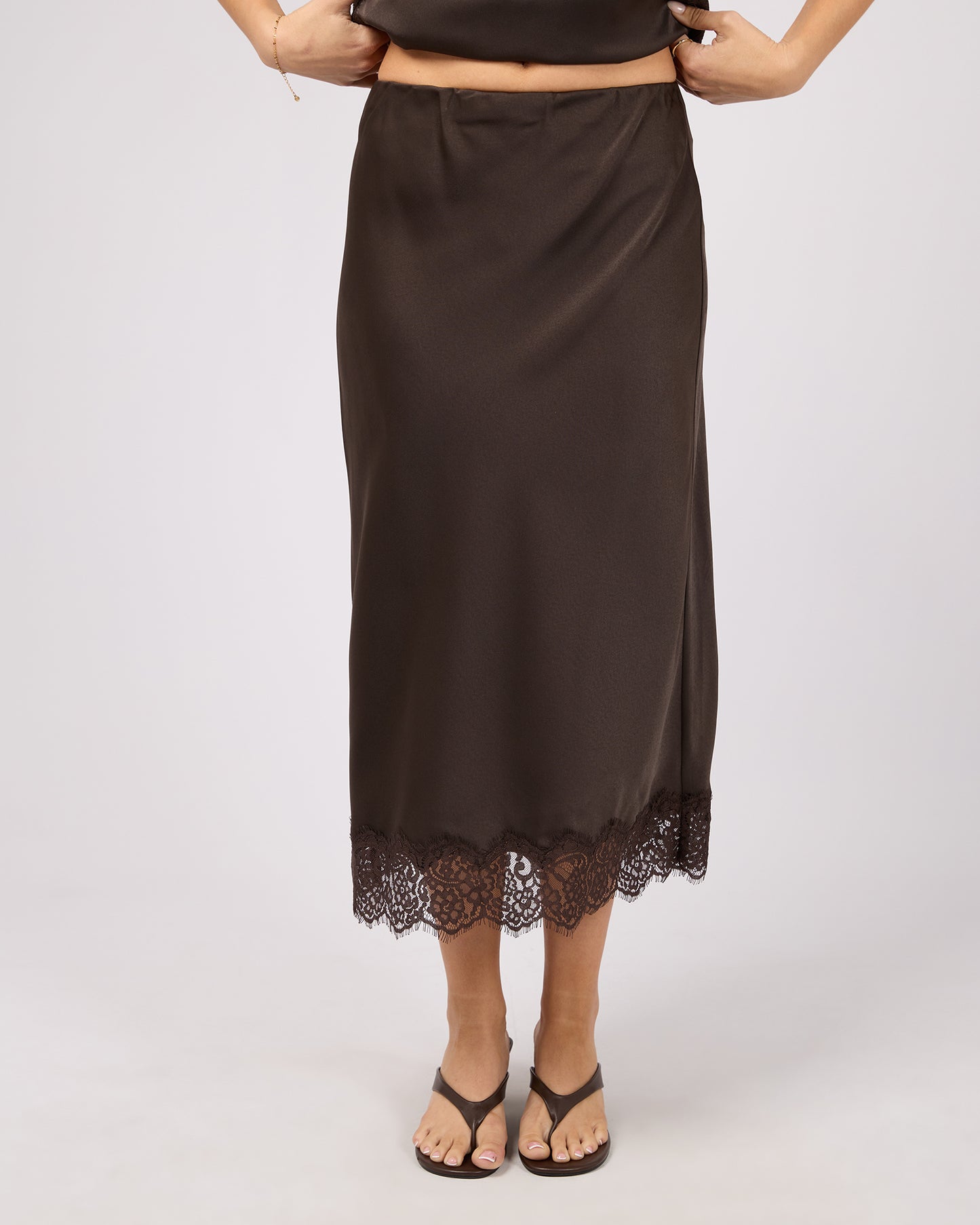 Brown slip skirt with lace hem on a white background. Hava Lace Skirt Coffee - The Rose Edit