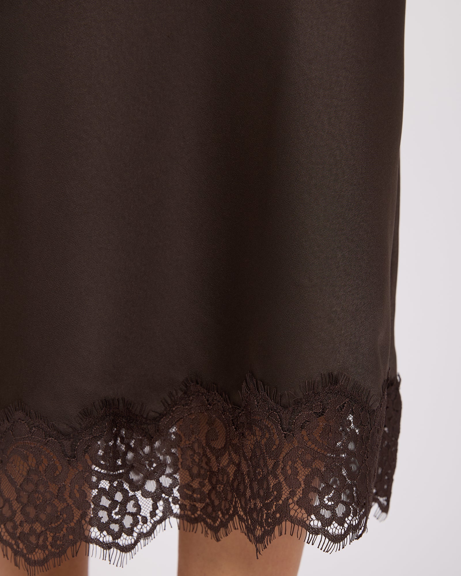 Brown lace-trimmed garment on a white background. Hava Lace Skirt Coffee - The Rose Edit