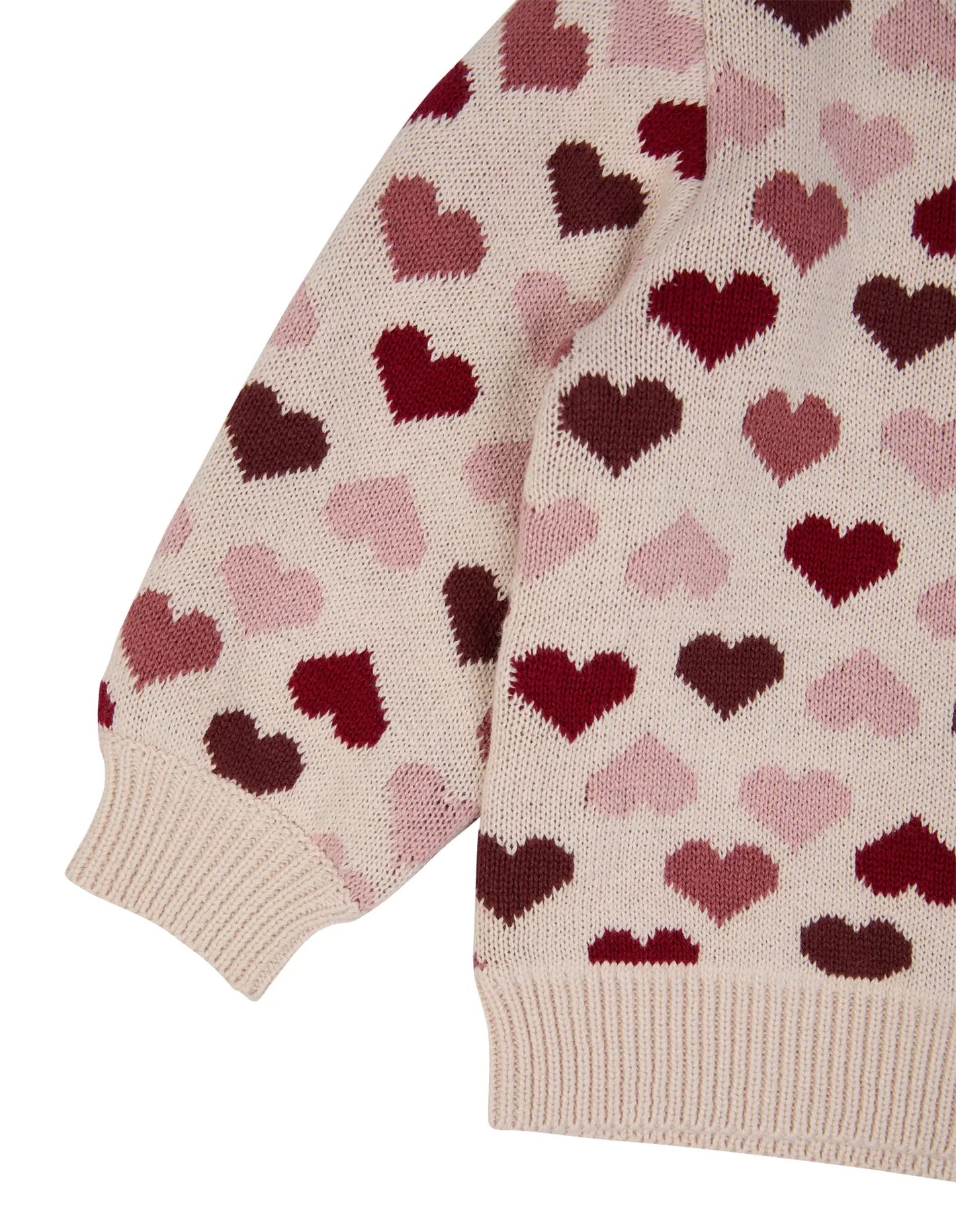 Close-up of a sweater with heart pattern on a beige background