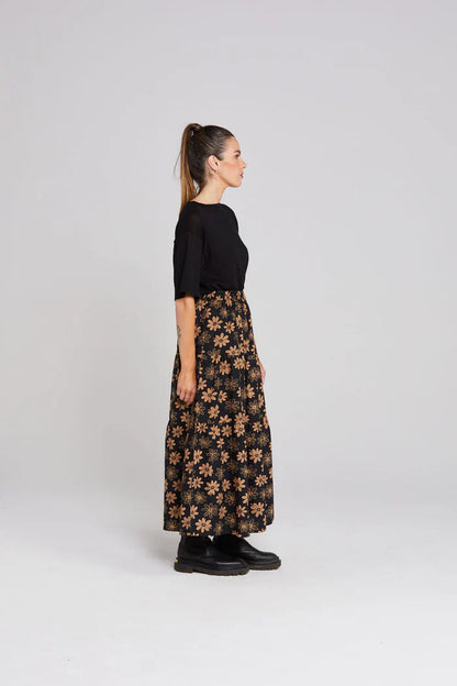 Woman wearing a black floral dress on a white background