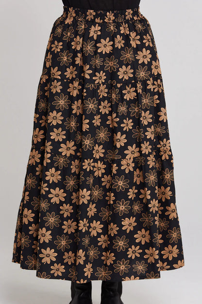 Black skirt with gold floral pattern on a white background