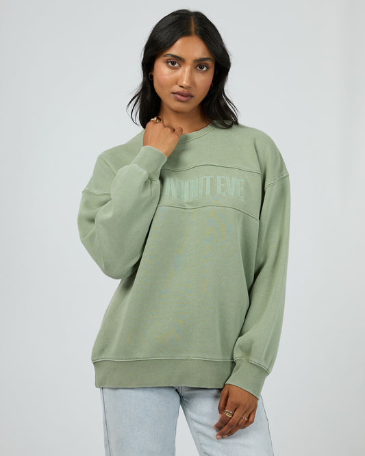 Woman wearing a green sweatshirt with text on a white background